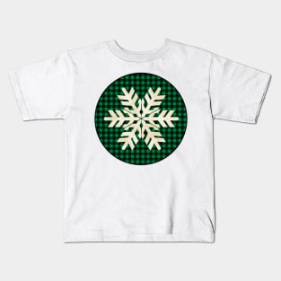 Snowflake silhouette over a black and green tile pattern Kids T-Shirt